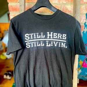 Mens t-shirt size medium “still here, still livin”. Excellent preowned condition